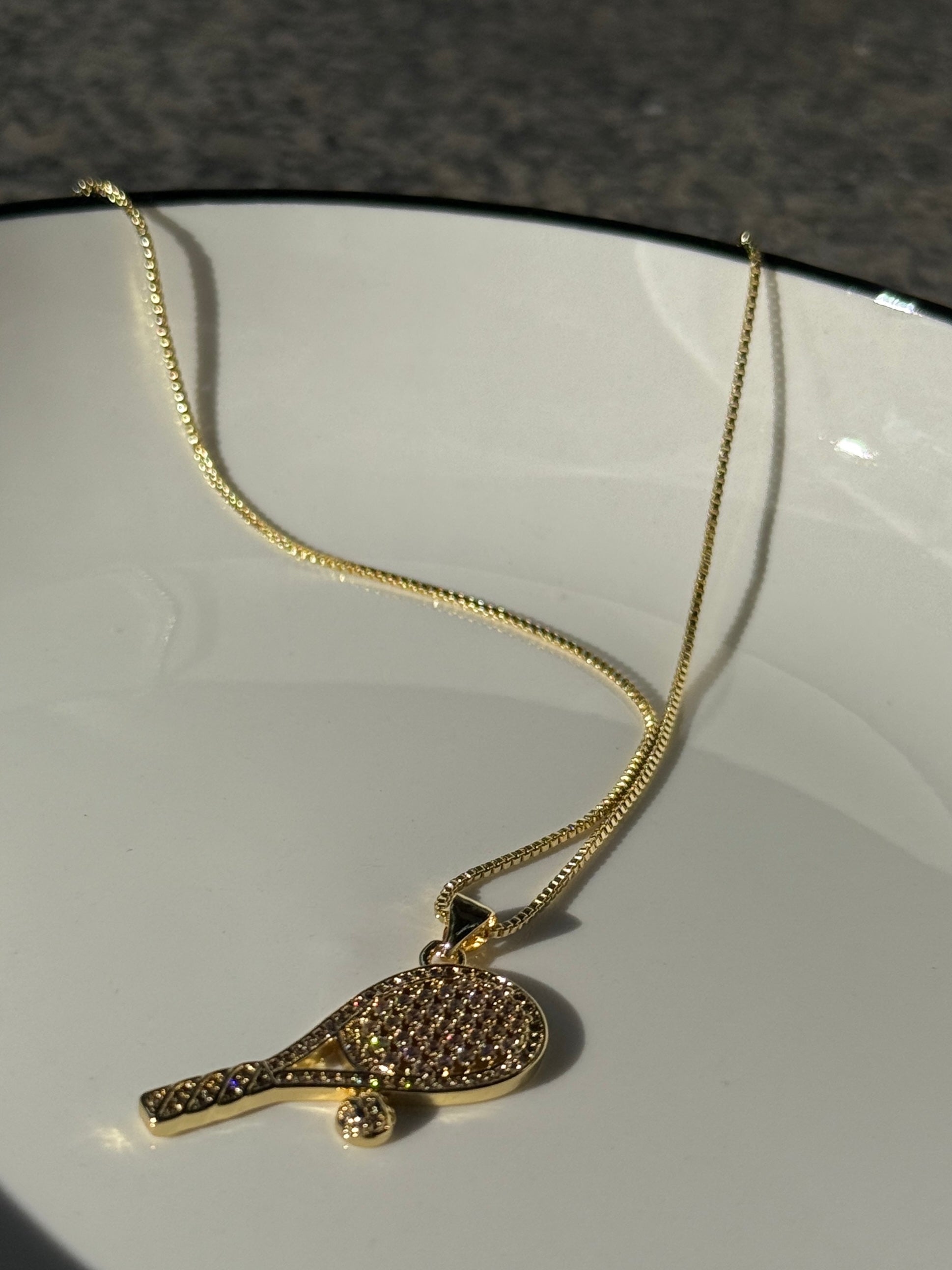 18K real gold-plated copper tennis-racket necklace paved with zircon – tennis jewelry in {{ product_color }} | Aura Tide Collective | Shop 18K real gold-plated copper tennis-racket necklace paved with zircon online for {{ product_tags | join: ", " }} – Fast shipping worldwide.