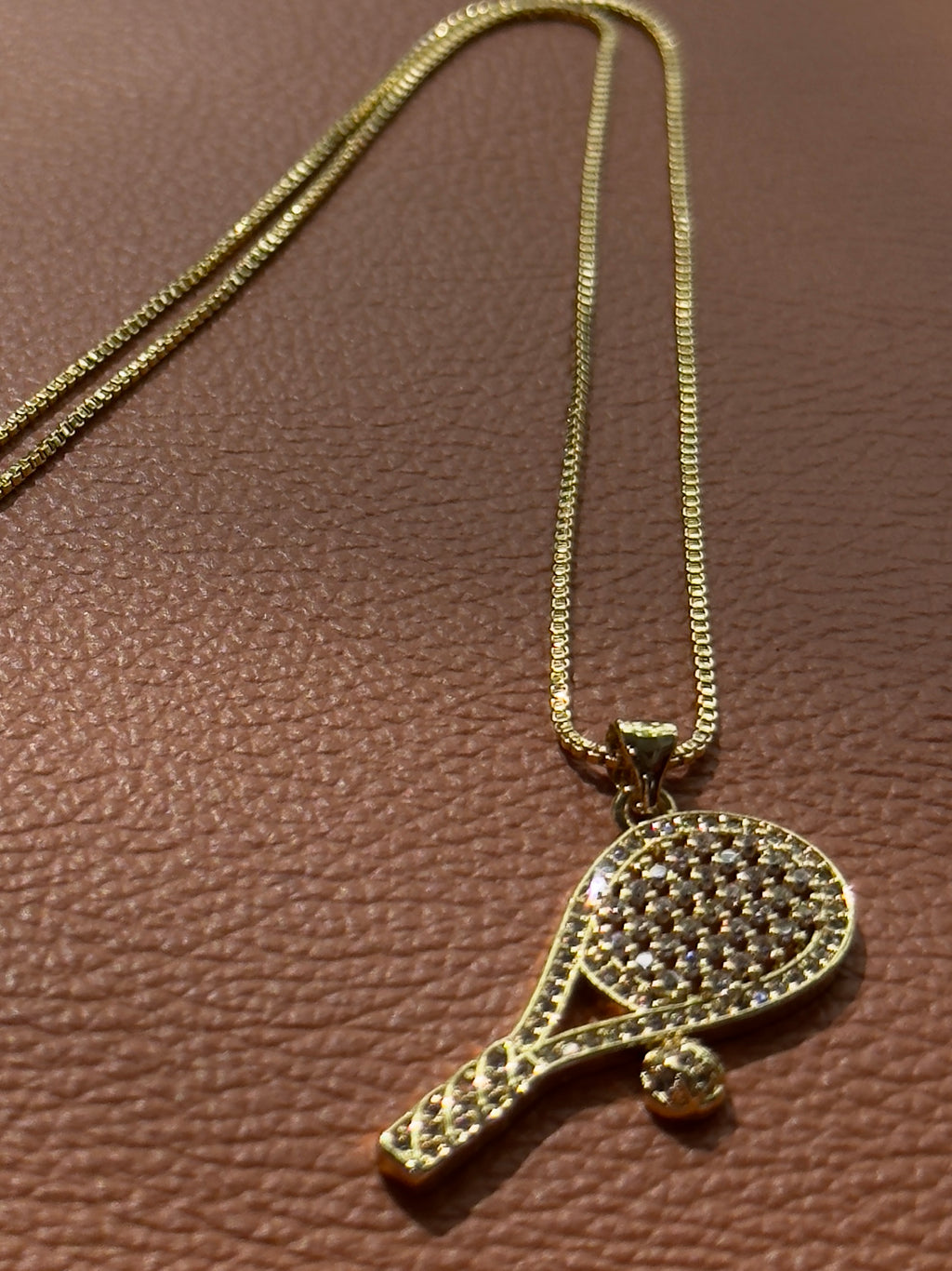 18K real gold-plated copper tennis-racket necklace paved with zircon – tennis jewelry in {{ product_color }} | Aura Tide Collective | Shop 18K real gold-plated copper tennis-racket necklace paved with zircon online for {{ product_tags | join: ", " }} – Fast shipping worldwide.