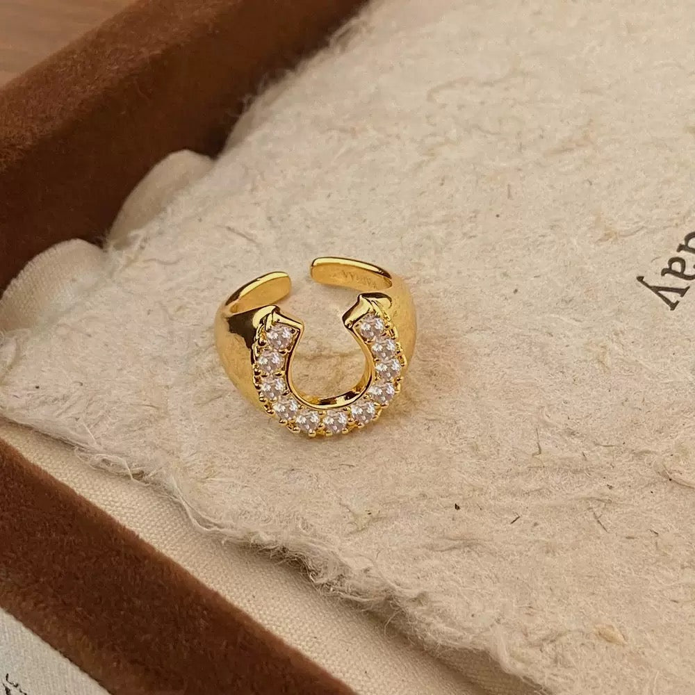 Brass electroplated gold horseshoe-shaped adjustable ring – Equin jewelry in {{ product_color }} | Aura Tide Collective | Shop Brass electroplated gold horseshoe-shaped adjustable ring online for {{ product_tags | join: ", " }} – Fast shipping worldwide.