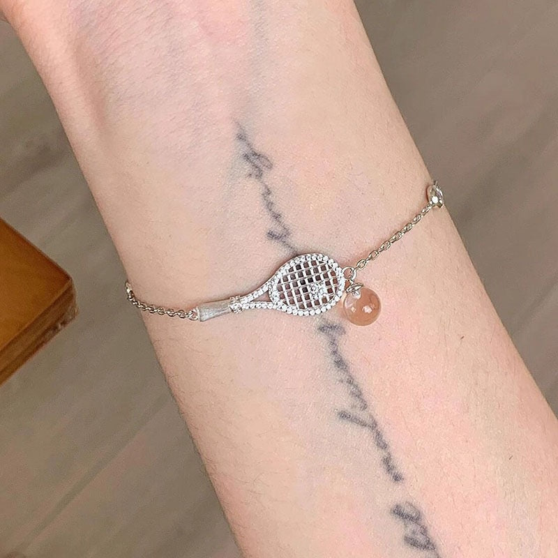 Old-money brushed-finish tennis-racket crystal-ball necklace & bracelet – tennis jewelry in {{ product_color }} | Aura Tide Collective | Shop Old-money brushed-finish tennis-racket crystal-ball necklace & bracelet online for {{ product_tags | join: ", " }} – Fast shipping worldwide.