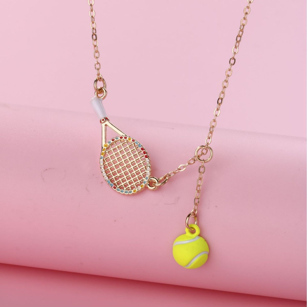 Kids Tennis racquet and tennis ball necklace – tennis jewelry in {{ product_color }} | Aura Tide Collective | Shop Kids Tennis racquet and tennis ball necklace online for {{ product_tags | join: ", " }} – Fast shipping worldwide.