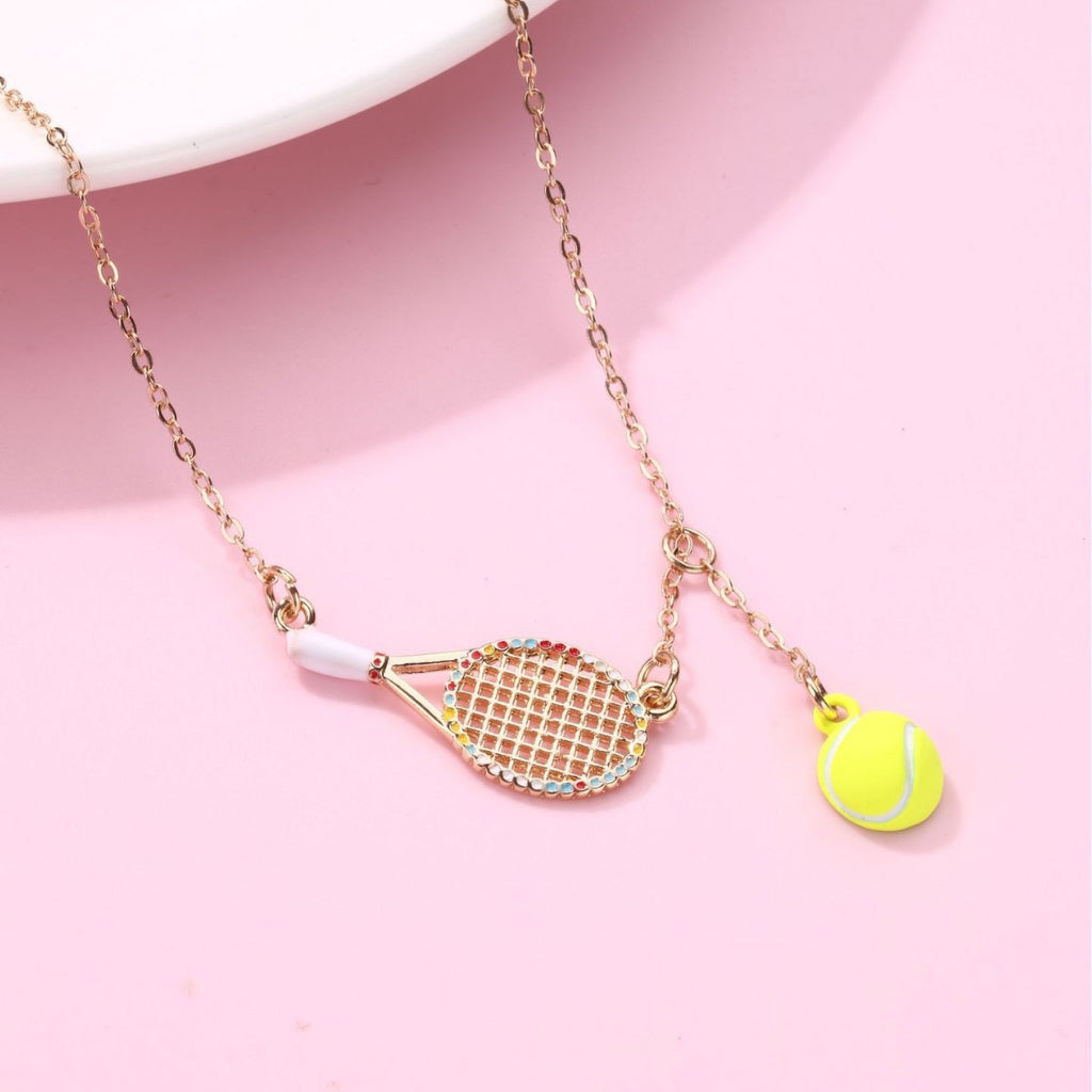 Kids Tennis racquet and tennis ball necklace – tennis jewelry in {{ product_color }} | Aura Tide Collective | Shop Kids Tennis racquet and tennis ball necklace online for {{ product_tags | join: ", " }} – Fast shipping worldwide.