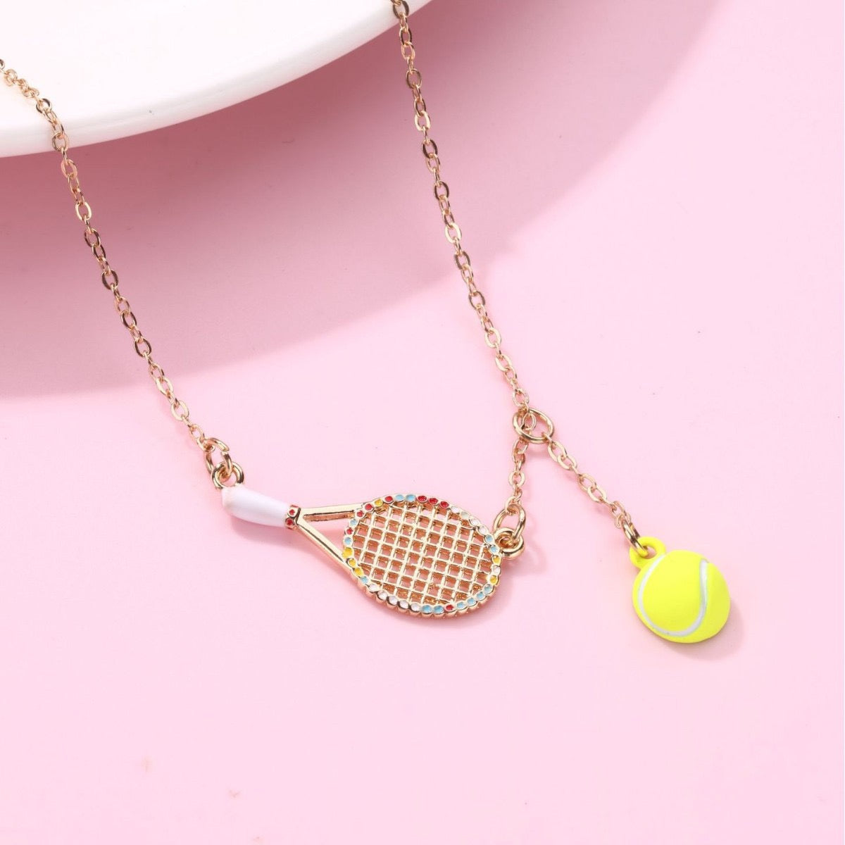 Kids Tennis racquet and tennis ball necklace – tennis jewelry in {{ product_color }} | Aura Tide Collective | Shop Kids Tennis racquet and tennis ball necklace online for {{ product_tags | join: ", " }} – Fast shipping worldwide.
