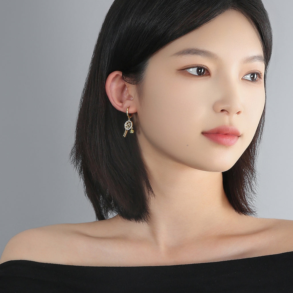 Aura flow tennis racquet earrings ear hoops – tennis jewelry in {{ product_color }} | Aura Tide Collective | Shop Aura flow tennis racquet earrings ear hoops online for {{ product_tags | join: ", " }} – Fast shipping worldwide.